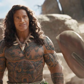 Dwayne Johnson as the demigod Maui holding his iconic fishhook next to Catherine Laga’aia as Moana in a stunning ocean environment.