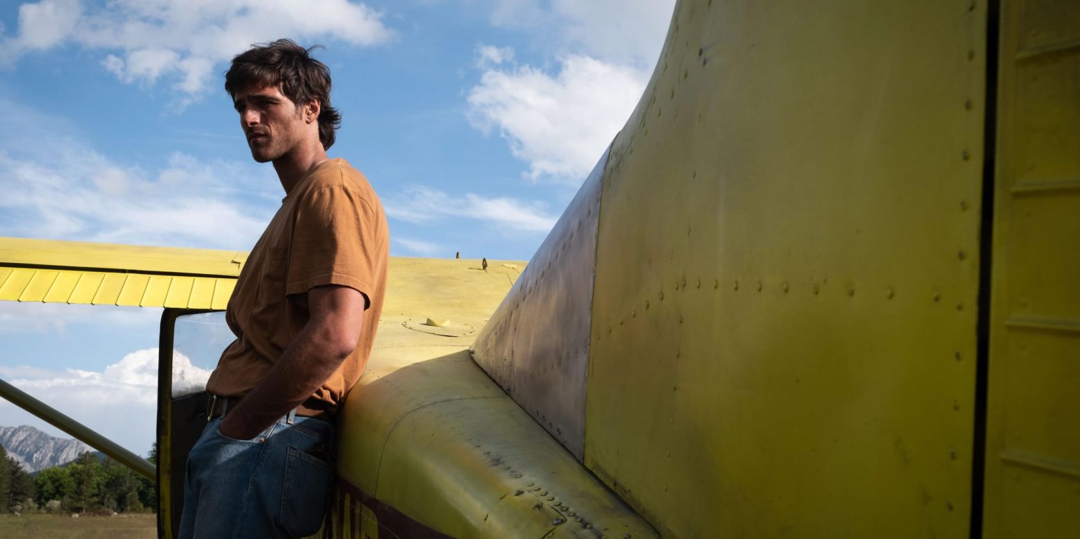 Jacob Elordi as Hig standing in a desolate post-apocalyptic Colorado landscape in Ridley Scott's The Dog Stars.