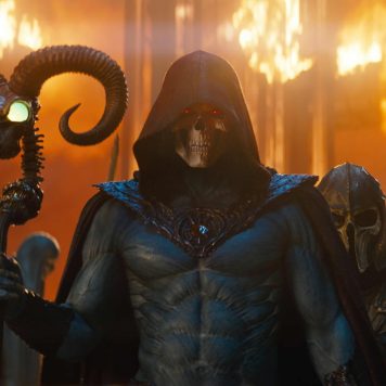 Nicholas Galitzine as He Man holding the magical Power Sword alongside Idris Elba as Man at Arms in a massive practical set.